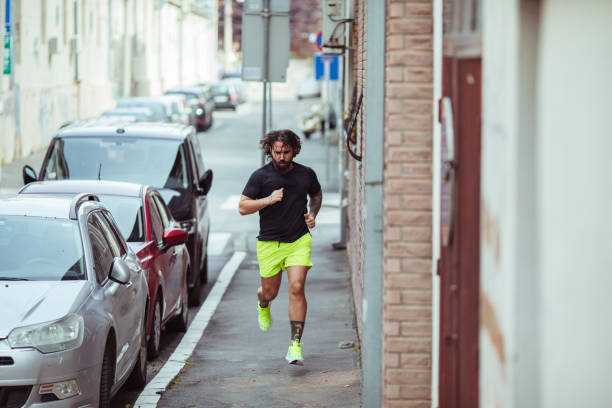 istock Young man jogging on a street 1493356486