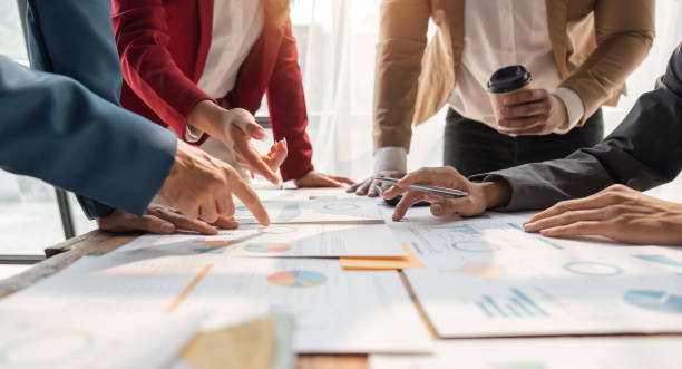 istock Financial analyst analyzes business finance reports on laptop and graph documents during corporate meeting discussions showing successful teamwork, business meeting ideas, marketing 1493357049