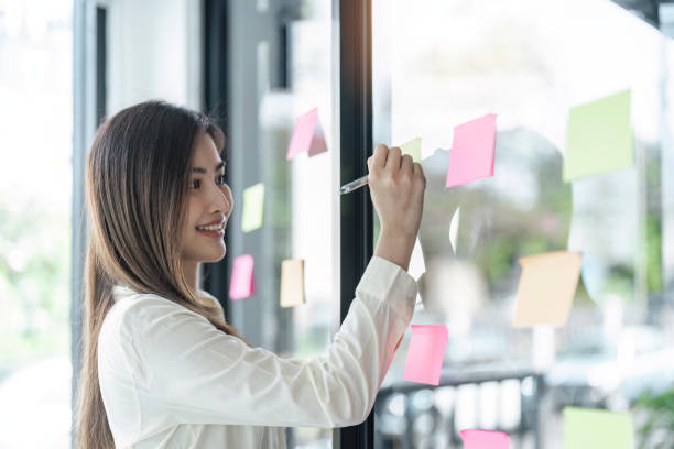 istock business woman write on colorful sticky notes develop business project in office, business woman brainstorm engaged in creative thinking make startup plan 1493360688
