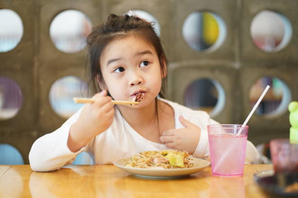 istock Young asian children enjoy eating Yakisoba by using chopsticks 1493364978