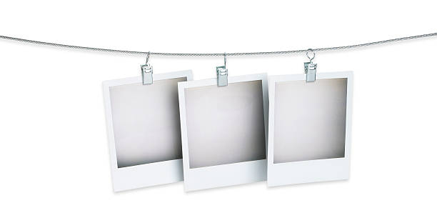 istock three blank polaroid pictures hanging on a wire with path 149336562
