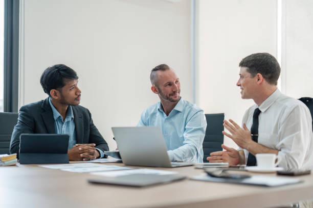 istock Business people, conversation and laptop data with planning and strategy in office. Training, communication and online chart with corporate paperwork and working on a teamwork project with diversity 1493366816