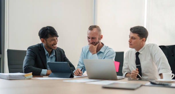istock Business team discussing online project, showing computer presentation to skilled team leader. Friendly diverse colleagues working in pairs on laptop 1493366911