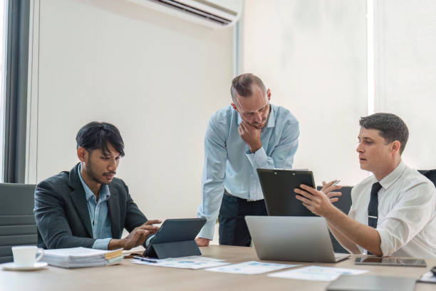 istock Business people, conversation and laptop data with planning and strategy in office. Training, communication and online chart with corporate paperwork and working on a teamwork project with diversity 1493367004