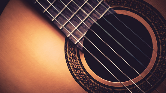 Close up of acoustic guitar, vintage filter. Music instrument concept.