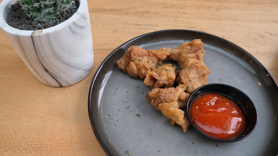 Chicken karage served with chili sauce on plate