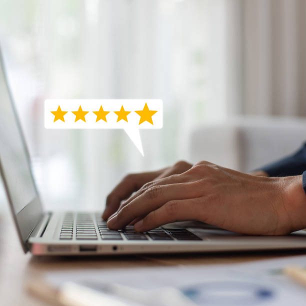 istock Customer using hand pressing keyboard on laptop with gold five star rating feedback icon and press level excellent rank for giving best score point to review the service , business concept 1493381295