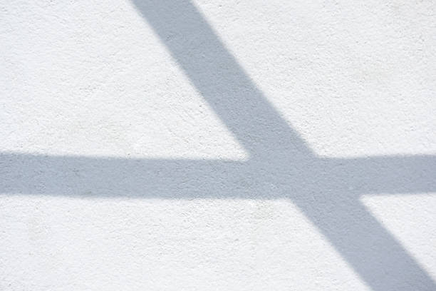 istock Abstract background of cross shadows on a white wall. 1493381449