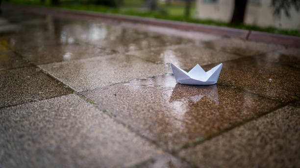 istock Lonely white paper boat called peace floating on a stream 1493381622