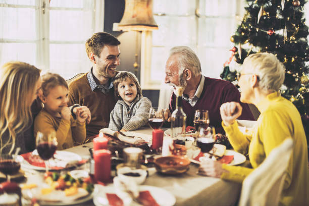 istock Happy extended family talking during New Year's lunch at home. 1493385452