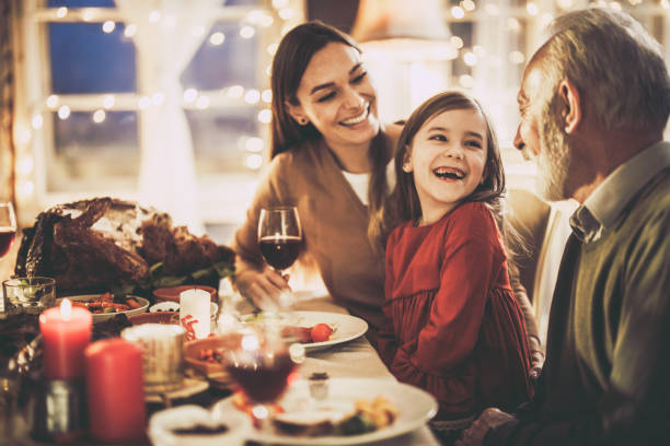 istock Happy extended family talking during Thanksgiving lunch at home. 1493385532