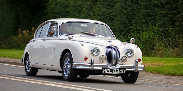 Bicester, Oxon, UK, October 10th 2021. 1966 JAGUAR MK II classic car travelling on an English country road