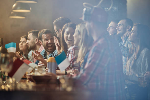 istock Large group of happy people talking in a bar. 1493387646