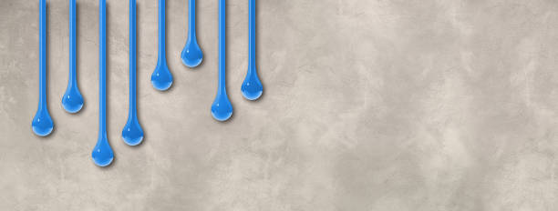 istock Blue ink drops on light concrete wall. Horizontal banner 1493387690