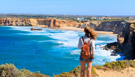 Woman tourist contempling atlantic ocean in Portugal