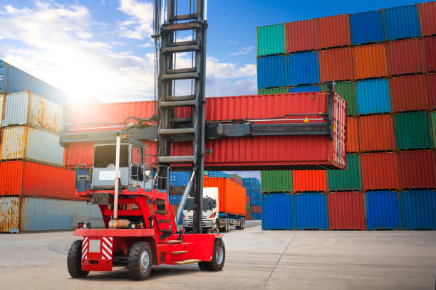 istock Container Crane Tractor Lifting up Stacking Cargo Container. Handling of Logistics Transportation Industry. Cargo Container ships, Freight Trucks Import-Export. Distribution Warehouse Shipping. 1493390725
