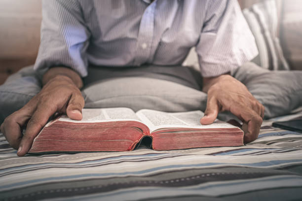 istock Close up one christian reading Bible on bed. christian concept. 1493393636
