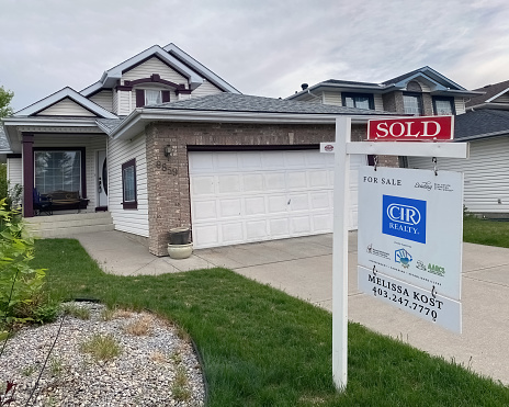 Calgary, Alberta, Canada. May 25, 2023. A close up to a Real Estate CIR Reality sign with a SOLD house.