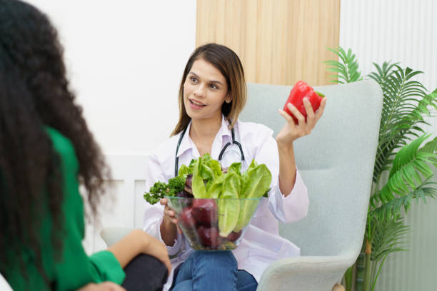 istock Woman talking with doctor - nutritionist. 1493395543