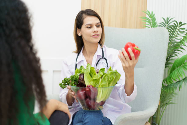 istock Woman talking with doctor - nutritionist. 1493395545