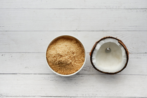 coconut sugar in a white bowl on table ,