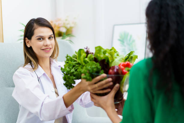 istock Woman talking with doctor - nutritionist. 1493396121