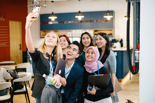 Group of conference presenters taking a selfie together before the seminar start.