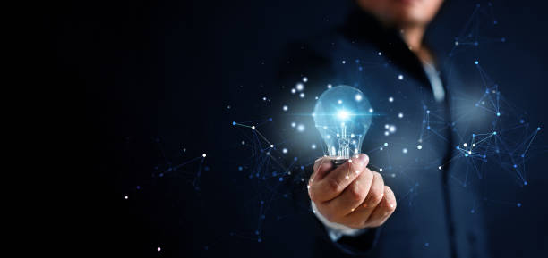 istock Glowing illuminated blue lightbulb in businessman hand with network connection line. Innovative idea and inspiration concept. Business man in suit holding creativity bulbs shining and glittering. 1493399026