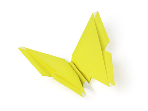 Yellow origami butterfly on the white background