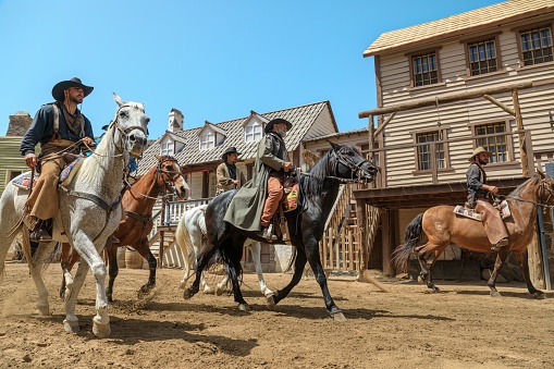 Cowboy wrangler ranch hand on horse roping horses in Westcliffe, CO, USA - 1/25/2020