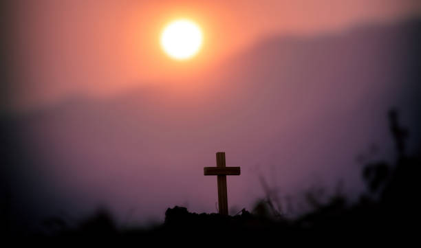 istock The cross standing with light sunset background. christian silhouette concept 1493402315