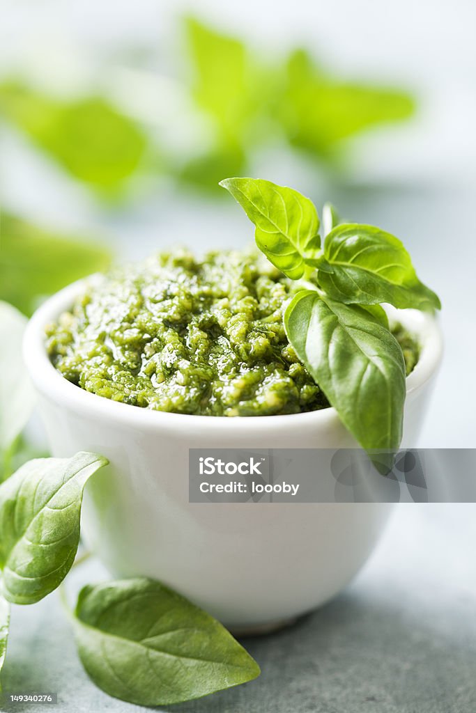 Bowl of pesto with plant leaves closeup of freshly made pesto Basil Stock Photo