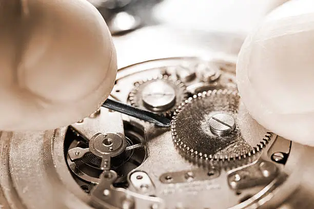 antique pocket watch being repaired ,sepia toned