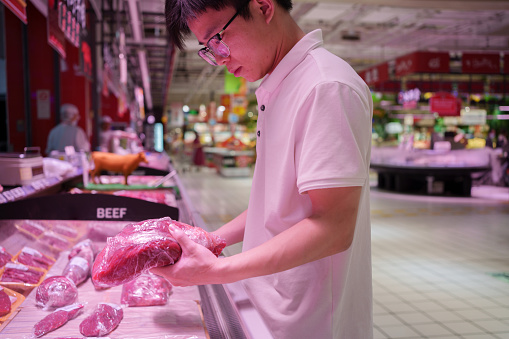 man shopping for beef