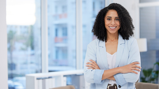 Business woman, leadership and portrait smile with arms crossed in corporate management at the office. Happy confident African American female leader, manager or CEO smiling for career success