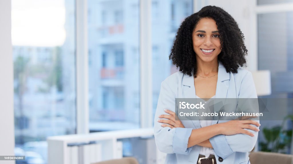 Business woman, leadership and portrait smile with arms crossed in corporate management at the office. Happy confident African American female leader, manager or CEO smiling for career success Businesswoman Stock Photo
