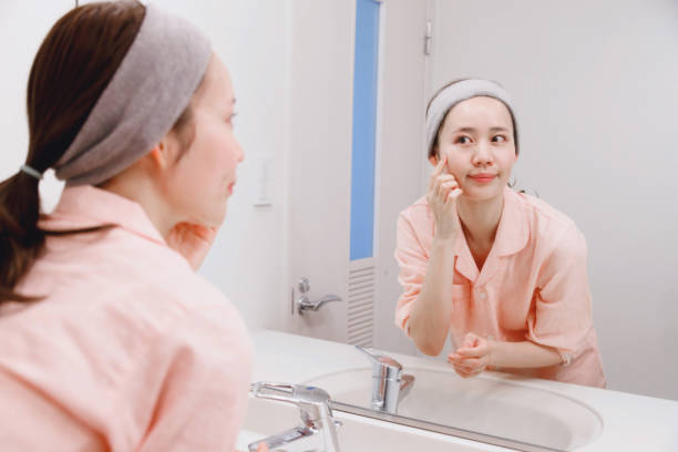 istock Japanese woman applying lotion on her face 1493416319