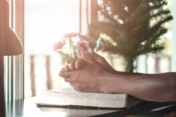 istock Close up hands praying on Holy Bible. christian concept. 1493416427