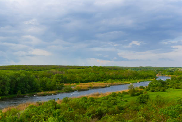 istock small calm river flow among green hills under cloudy sky 1493422355
