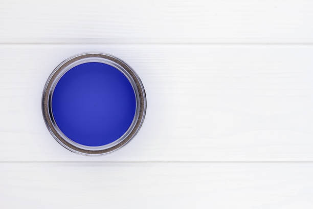 istock open can with blue paint on a white wooden background top view with copy space 1493422556