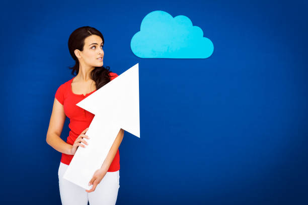 Young girl pointing to a blue cloud: cloud computing concept.