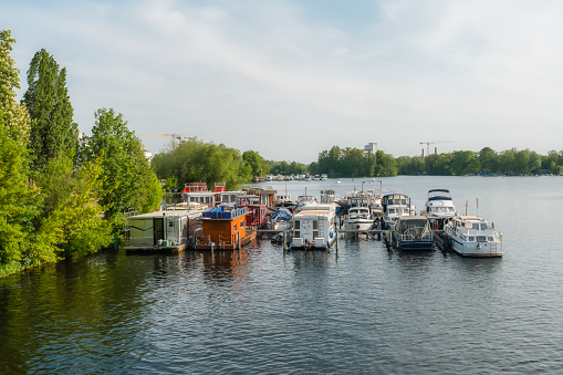 vessels and house boats anchored in havel river in Berlin Spandau at sunny day