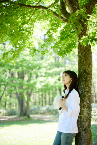 istock Japanese woman relaxing at forest 1493425003