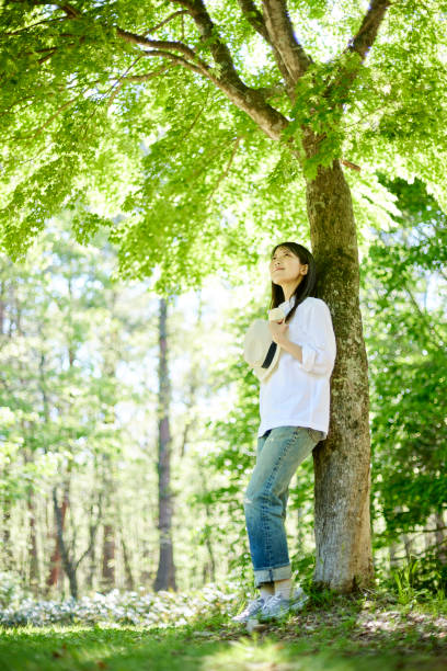 istock Japanese woman relaxing at forest 1493425006