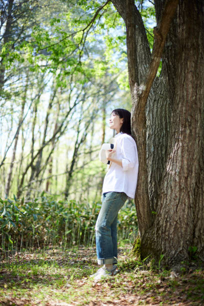 istock Japanese woman relaxing at forest 1493425537