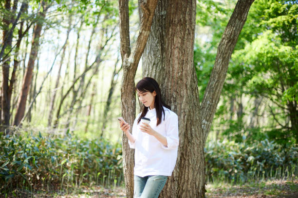 istock Japanese woman relaxing at forest 1493425540