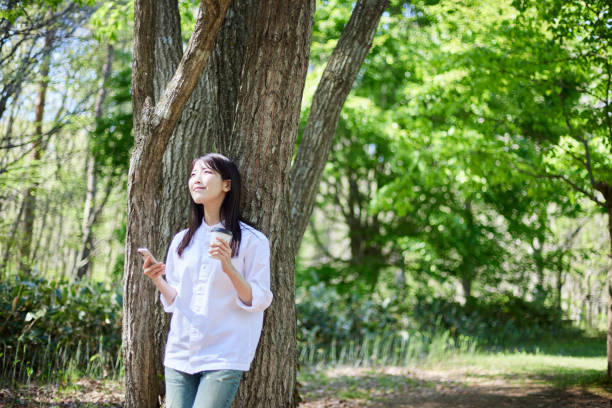 istock Japanese woman relaxing at forest 1493425541