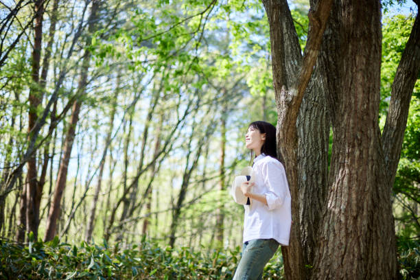 istock Japanese woman relaxing at forest 1493425548