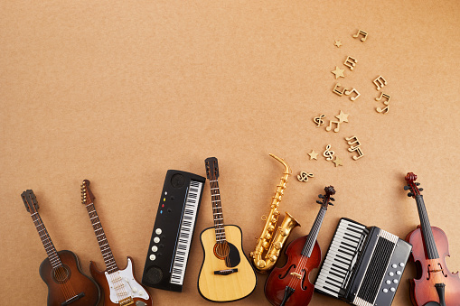 Happy world music day. Musical instruments on brown background