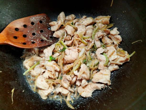 istock Cooking Stir fried Chicken and Shredded Ginger - food preparation. 1493429165